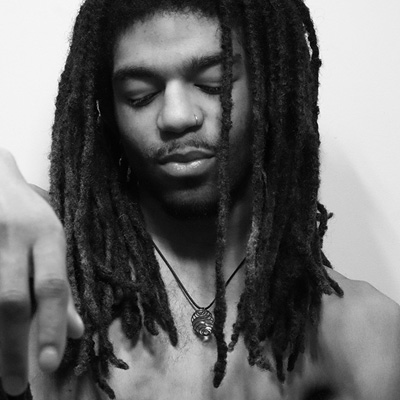 Greyscale moody photography of man with locs