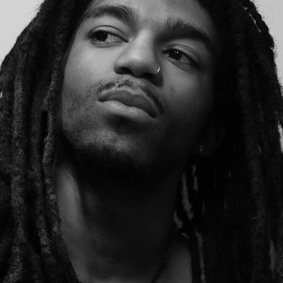 Greyscale moody photography of man with locs